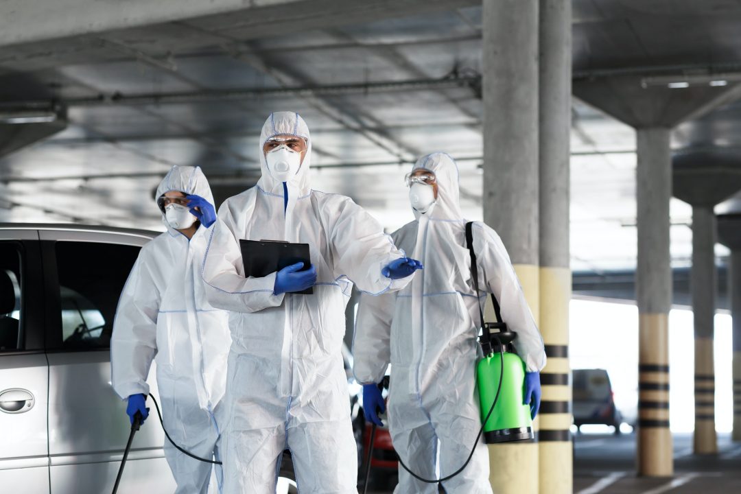 virologists-in-protective-suits-on-duty-on-public-parking-for-first-aid.jpg